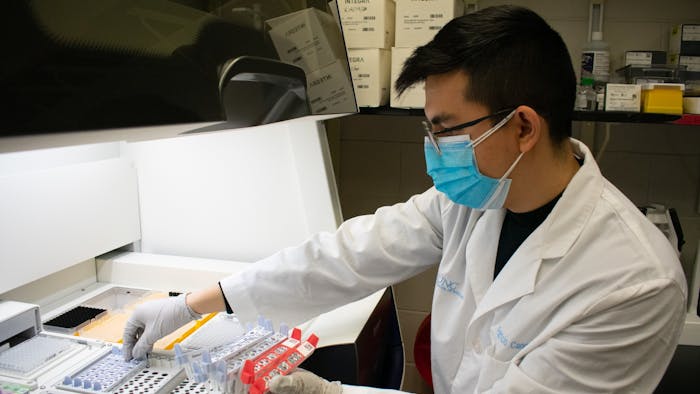 Patricio Cano uses laboratory equipment to assist in the CORVASEQ project at the UNC Lineberger Cancer Center on Monday, Jan. 31, 2022.