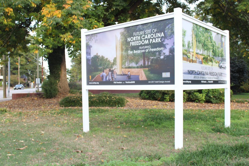 A sign indicates the future site of the Freedom Park at the corner of South Wilmington Street and East Lane Street in downtown Raleigh.
