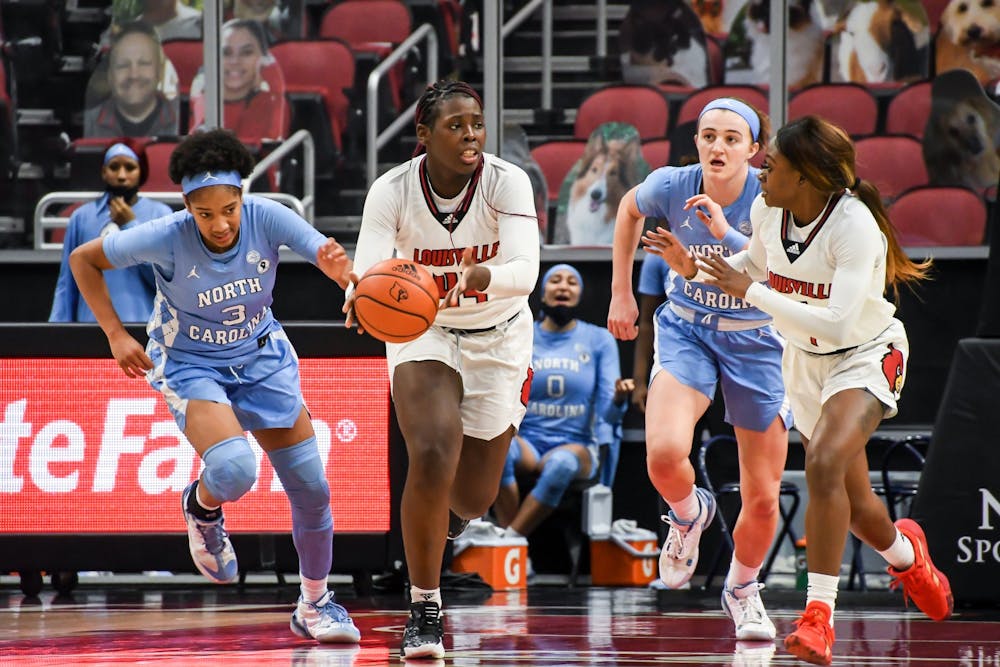 <p>Louisville's first-year forward Olivia Cochran (44) attempts to pass to senior guard Dana Evans (1) during a game against UNC on Thursday, Jan. 28, 2021. UNC fell to the Cardinals 68-79. Photo courtesy of Jared Anderson.</p>