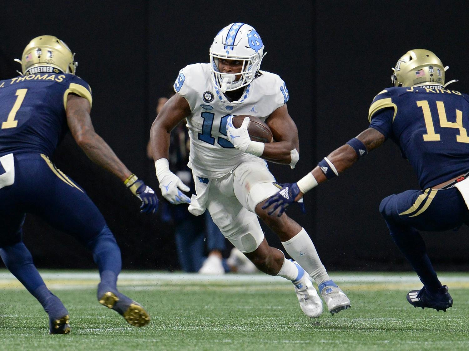 UNC graduate running back Ty Chandler (19) sprints by his opponents during UNC football's away game against Georgia Tech in the Mercedes-Benz Stadium in Atlanta, GA, on Sept. 25. Photo courtesy of UNC Athletic Communications.