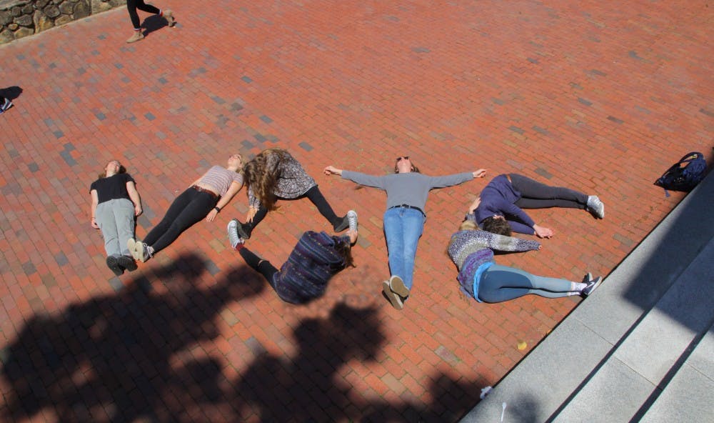 <p>A handful of students — including first-years Becca Brandes, Molly Cartwright and Helen Hill — spelled it out for their peers in front of Polk Place.</p>