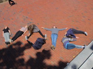 A handful of students — including first-years Becca Brandes, Molly Cartwright and Helen Hill — spelled it out for their peers in front of Polk Place.