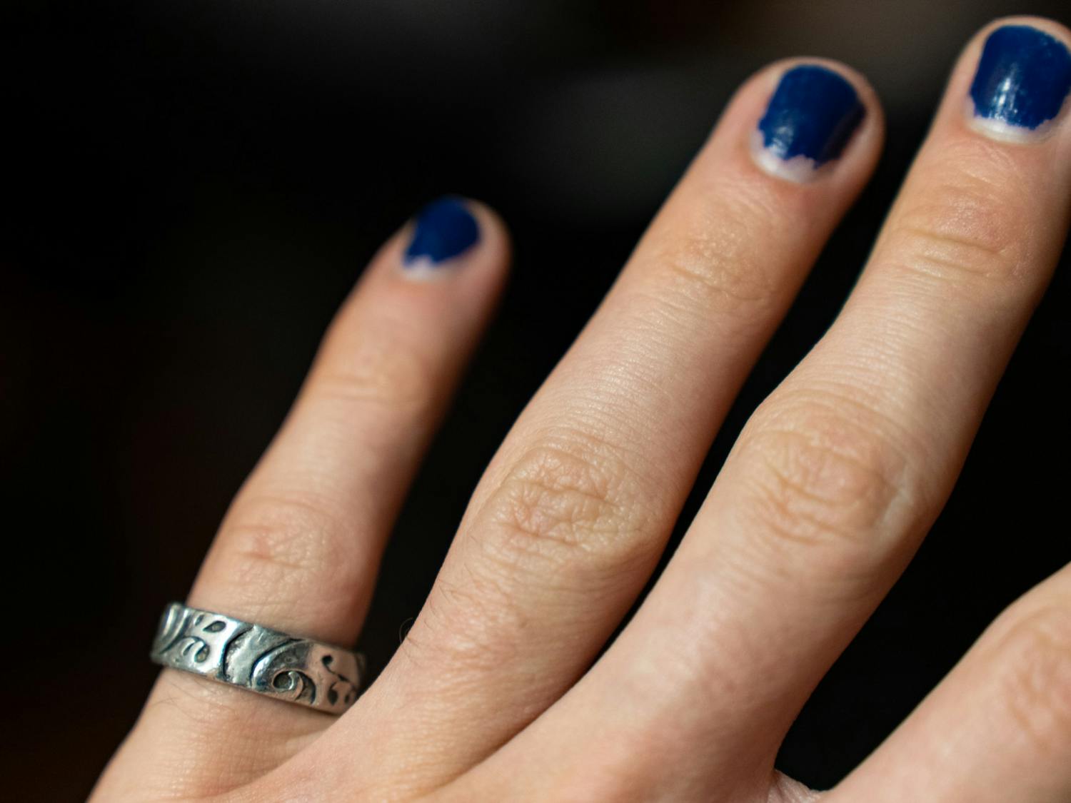 DTH Photo Illustration. A UNC student wears a ring on his finger.