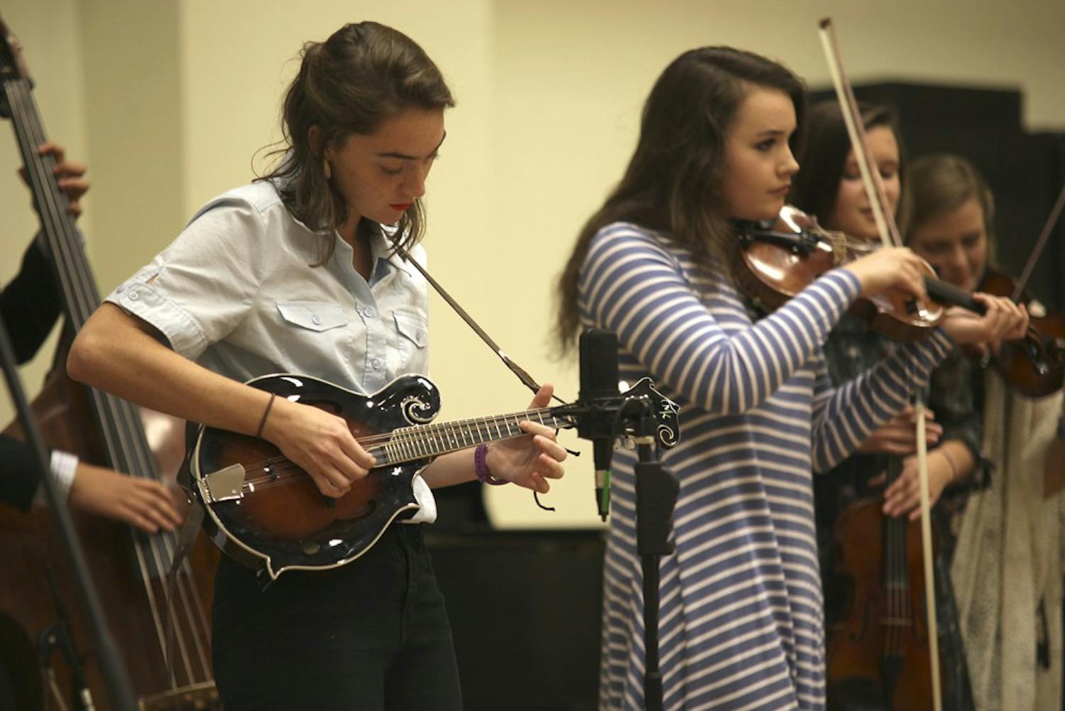 Maddie Fisher plays mandolin for the Carolina Blue Grass Band during a concert Thursday evening.