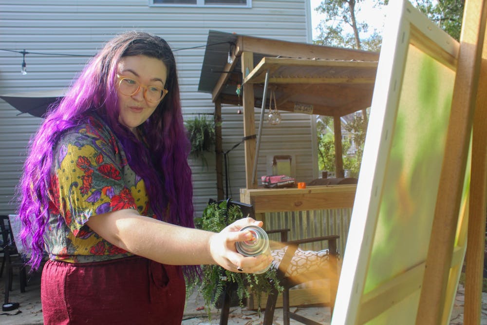 Sarah Booth, a former student at School of the Art Institute of Chicago, spends her evening testing out new art mediums in her backyard. "Lately I've been doing things a little non-traditional and I love it," she said.