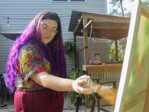 Sarah Booth, a former student at School of the Art Institute of Chicago, spends her evening testing out new art mediums in her backyard. "Lately I've been doing things a little non-traditional and I love it," she said.