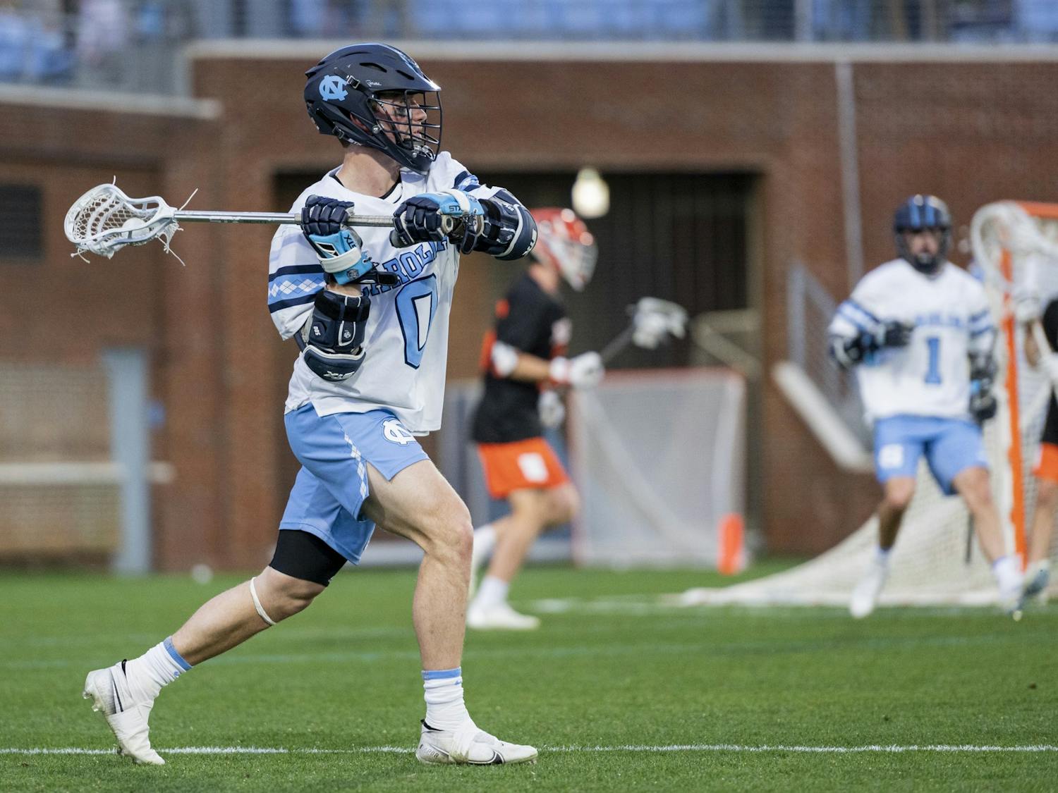 UNC senior attackman Lance Tillman (0) passes the ball during the men’s lacrosse game against Mercer at Dorrance Field on Friday, Feb. 10, 2023. UNC won 25-3.
