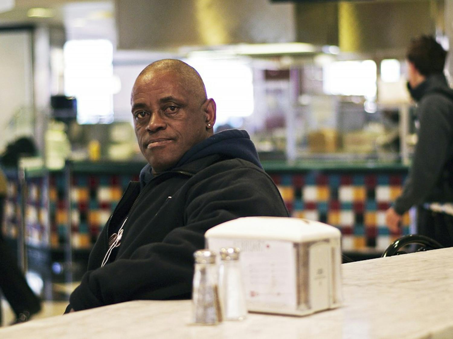 Ernest Freeman, a Rams Head Dining Hall employee from Chapel Hill, sits at a table in the dining hall where he works on Tuesday afternoon. Freeman has been writing poems since he was five years old. 