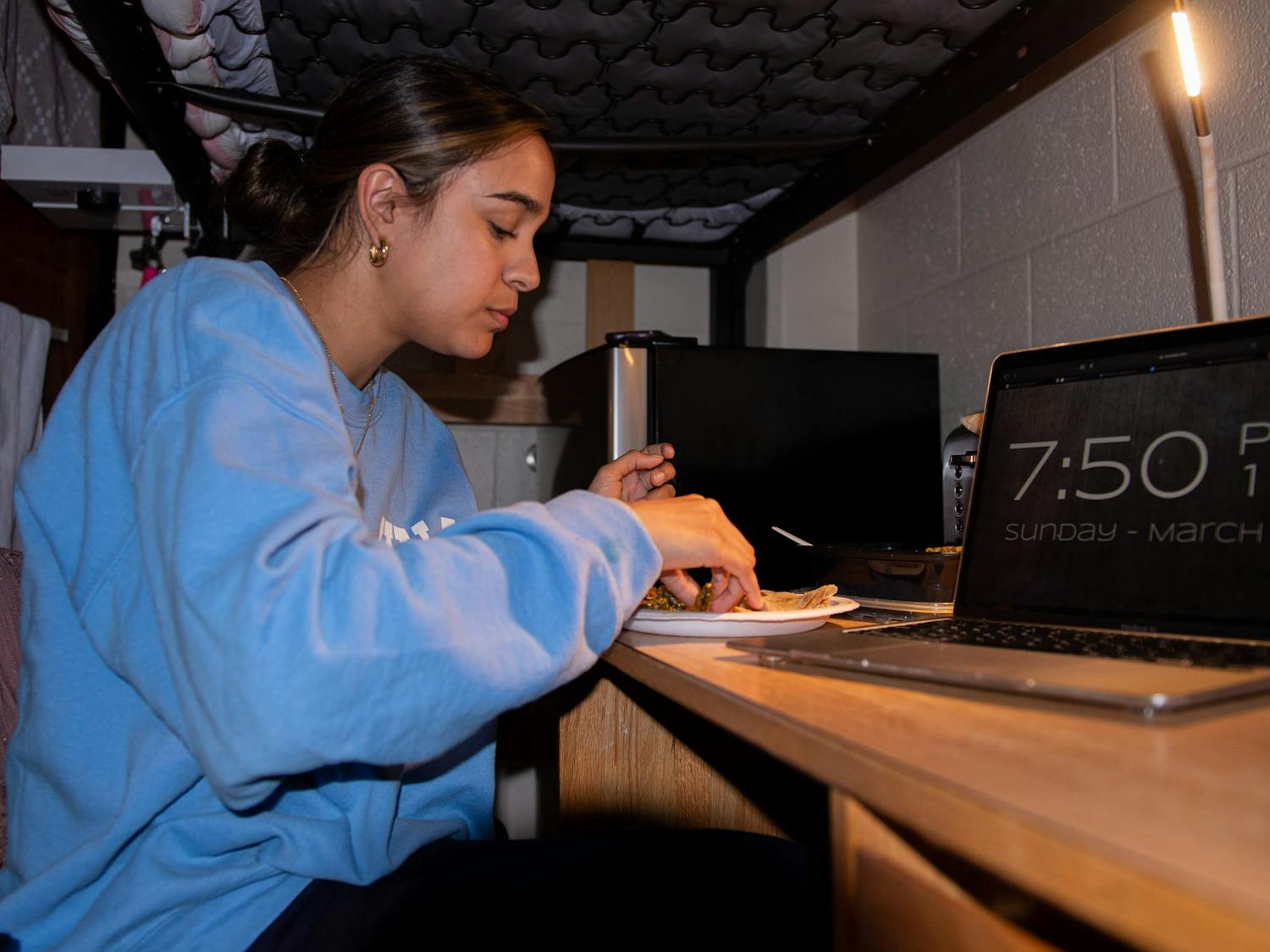 Noor Kazi, a UNC sophomore in the Islamic community, breaks her fast after sunset during Ramadan in her dorm room on Sunday, March 26, 2023.