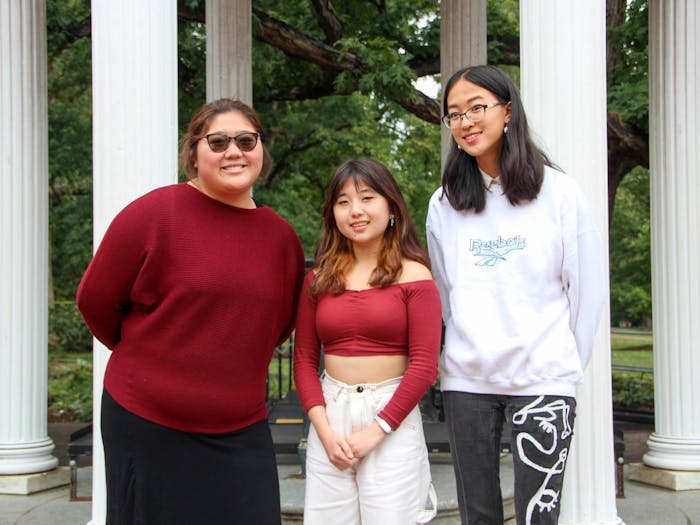 Sophomore Joy Jiang, first-year Christina Huang, and sophomore Sarah Zhang pose for a portrait at the Old Well on Oct. 3, 2022. The UNC for Affirmative Action group aims to defend diversity at UNC.