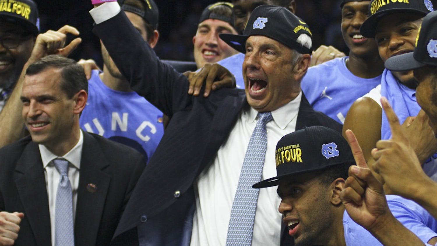 Roy Williams and the Tar Heels celebrate after their 88-74 win against Notre Dame Sunday, advancing them to the Final Four.