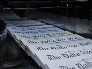 Newspapers come off the press to be bundled for delivery.&nbsp;