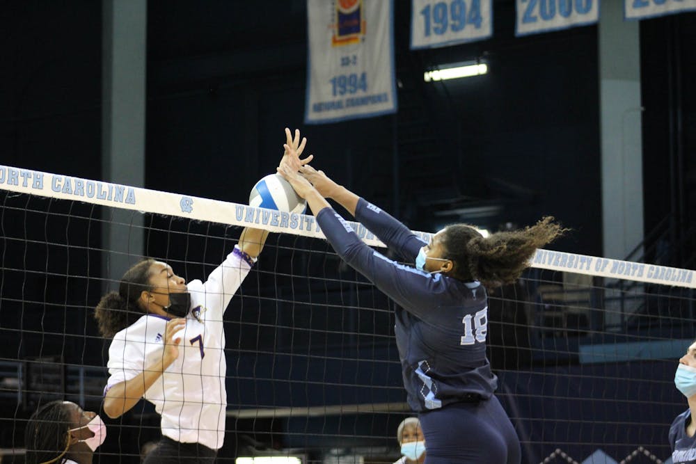 UNC graduate outside hitter Nia Robinson (18) blocks the ball during the UNC women's volleyball team's matchup against ECU on Sep. 4. The Tar Heels won in three sets, advancing their record to 6-0.