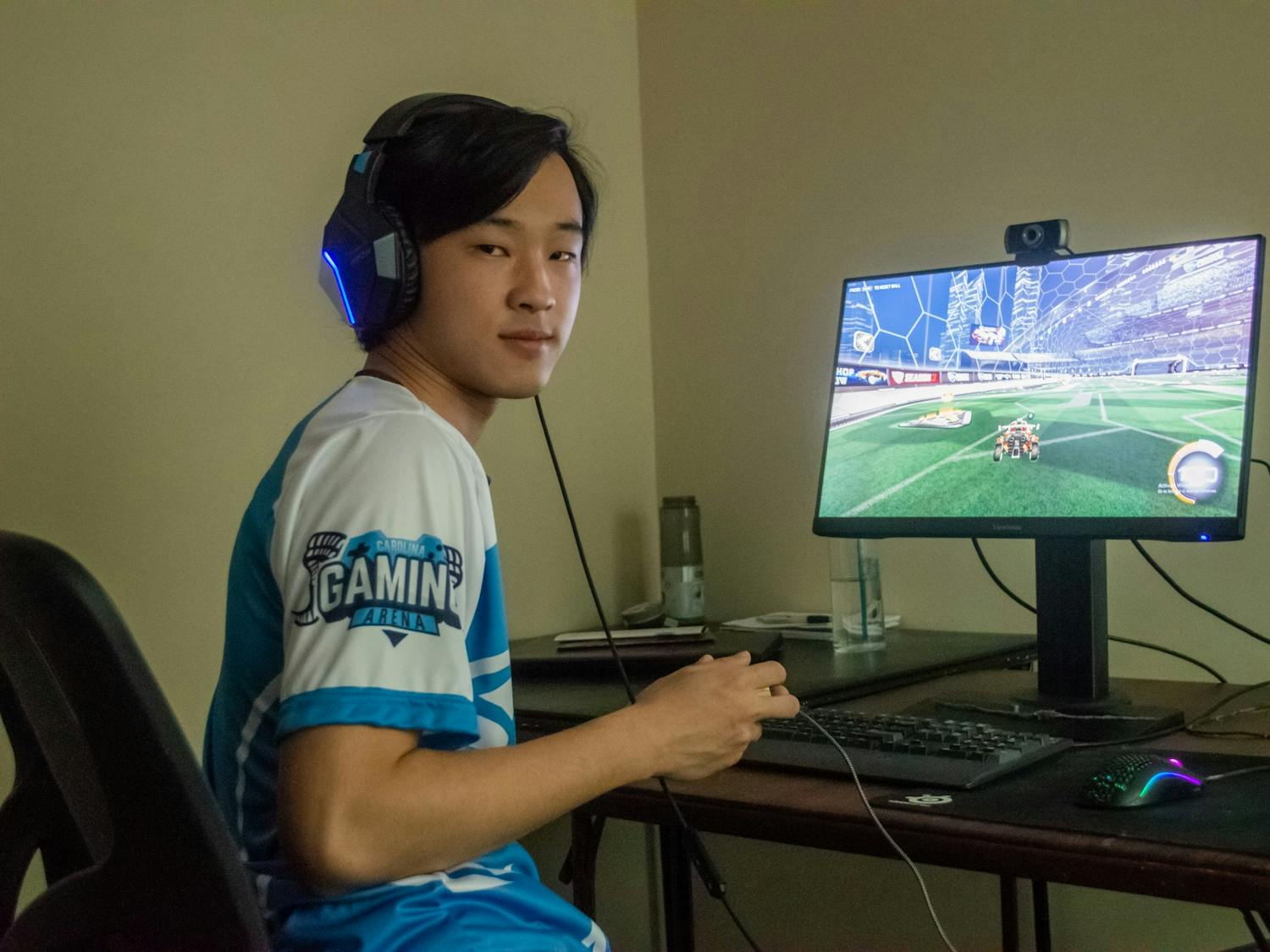 Jason Hu, a senior computer science and statistics double major and member of the UNC Rocket League Club poses in front of his computer on Wednesday May 19, 2021.