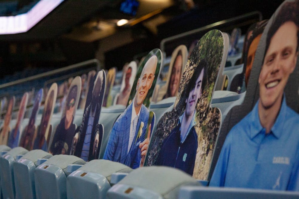 Cardboard cutouts of fans sit in the empty seats of the Smith Center before a game on Nov. 25, 2020 against the College of Charleston. Due to the ongoing COVID-19 pandemic, fans are not allowed to attend any UNC basketball games in person, prompting many teams, including the Tar Heels, to fill the empty seats with photos and cutouts of supporters.
