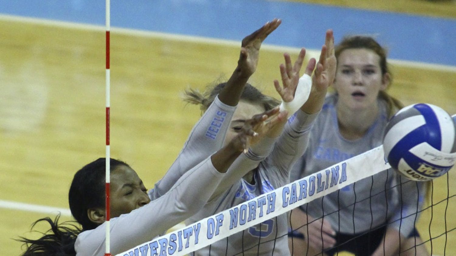 UNC outside&nbsp;hitter Taylor Leath (43) (left)&nbsp;and middle hitter&nbsp;Taylor Fricano (5) go up for a block against N.C. State on Wednesday.
