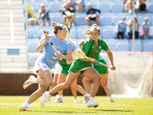 Junior midfielder Nicole Humphrey (9) runs the ball down the field during the UNC v. Notre Dame women's lacrosse game at Dorrance Field on Saturday, Apr. 2, 2022.