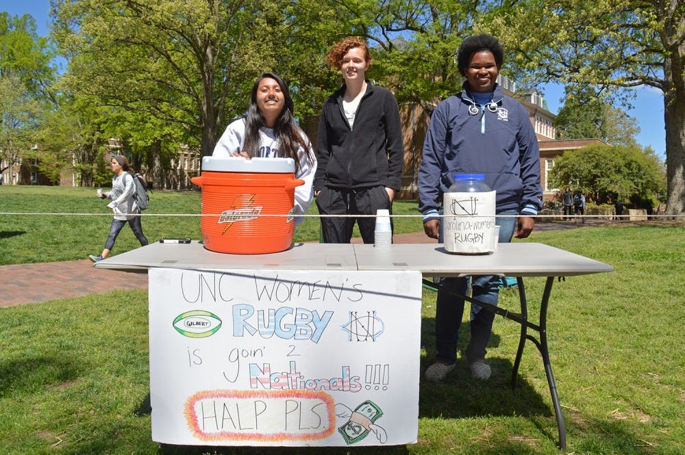 The Women's Rugby team is going to the national championship game but has to raise the money to get there. Kenya Hairston(left), a Psychology major from Class of 2017, Bridget Sheridan(middle), a freshman majors in Biology, and Amy Alam(left), double major in Psychology and Biology from Class of 2018, are raising the money for their team on campus on Apr.5. 