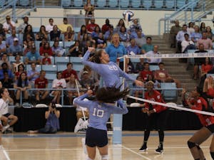 Ava Bell, freshman and middle blocker for UNC's women's volleyball team, jumps for the ball in a game against N.C. State on Wednesday, Sept. 26, 2018.