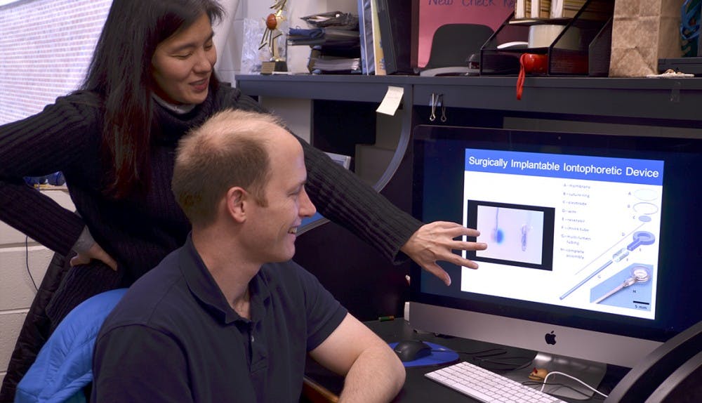 Associate professor of oncology Dr. Jen Jen Yeh and medical student James Byrne, Ph.D., in Yeh's lab in Lineberger Cancer Center. Yeh and Byrne worked together on a team of researchers to create a new device to treat pancreatic cancer directly at the site of the tumor.