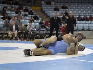 Graduate student Clay Lautt wrestles Ohio State senior Ethan Smith at Carmichael Arena on Sunday, Nov. 20, 2022. UNC lost to Ohio State 9-33.