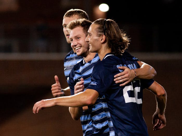 The UNC Tar Heels embrace after junior midfielder Cameron Fisher (17) scores the third goal of the game with an assist from midfielder/forward Ernest Bawa (20). The Tar Heels beat the Georgia Southern Eagles 3-0 at Dorrance Field on Friday, Sep. 3, 2021.