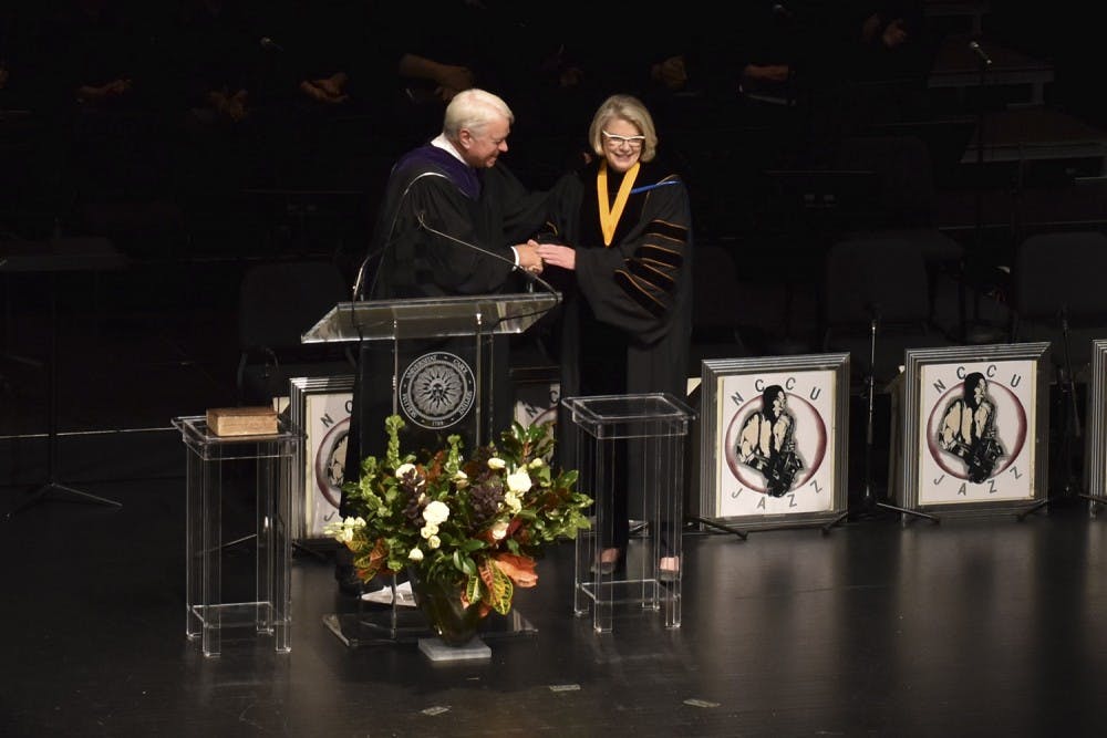 <p>Chair Bissette congratulates President Margaret Spellings at her inauguration on Thursday at Memorial Hall.&nbsp;</p>