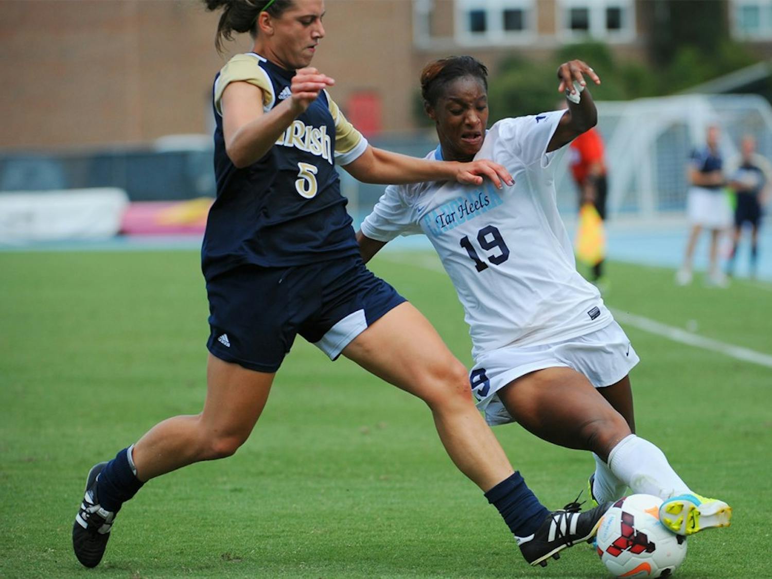 UNC midfielder Crystal Dunn (19) fights Notre Dame defender Cari Roccaro (5) for possession of the ball.