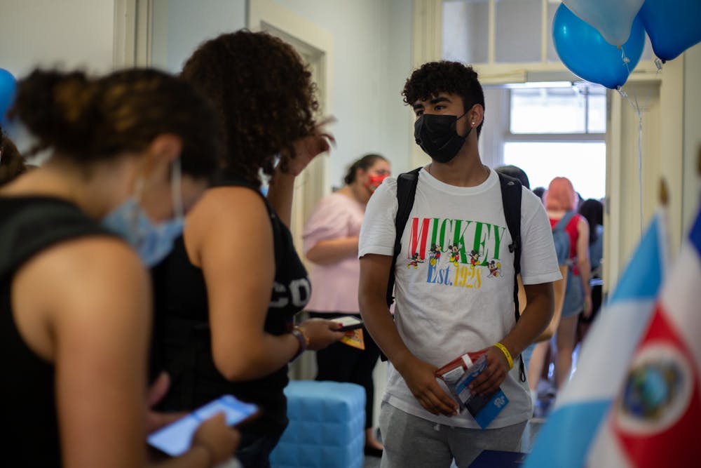 Eddy Velazquez, a sophomore pre-business major, talks to another student at the Carolina Latinx Center's open house event on Aug. 25.