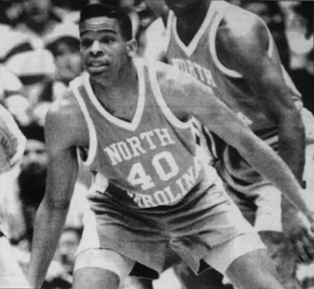 DTH Archive. Hubert Davis (40) plays defense against Duke during his time as a college player at UNC under coach Dean Smith.