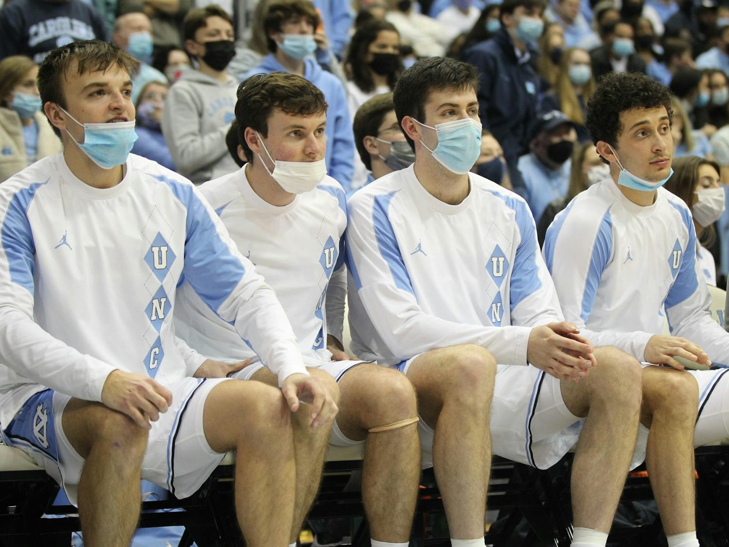Junior guard Jackson Watkins, sophomore guard Rob Landry, junior forward Duwe Farris and sophomore guard Creighton Lebo watch UNC basketball's home game against Virginia Tech on Monday, Jan. 24, 2022, at the Dean Smith Center. UNC won 78-68.
