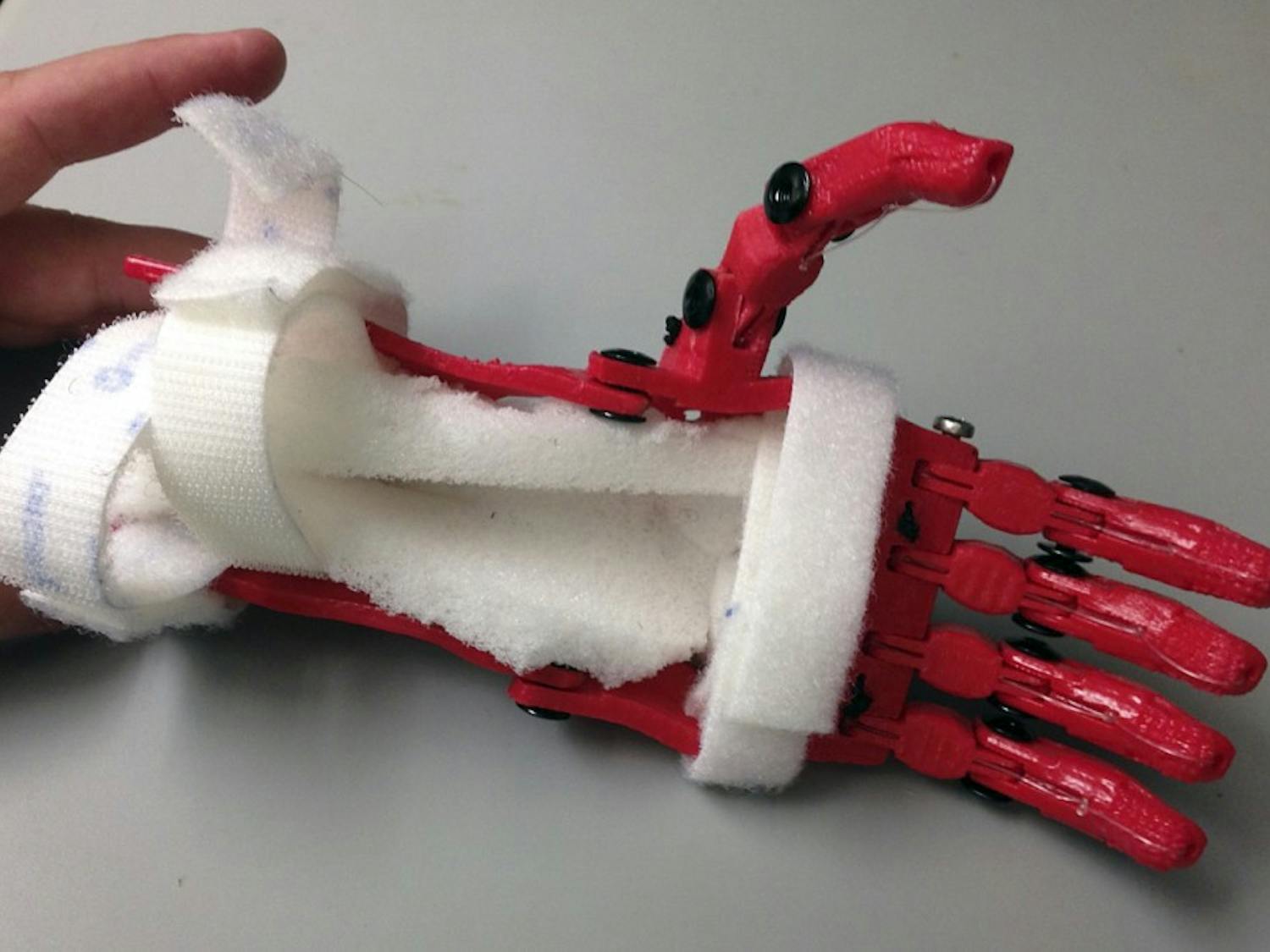 Jeff Powell, a senior biomedical engineering major and design chair of the UNC Biomedical Engineering Club, used a 3-D printer to make an affordable prosthetic hand for 7-year-old boy Holden Mora.Courtesy of Jeff Powell
