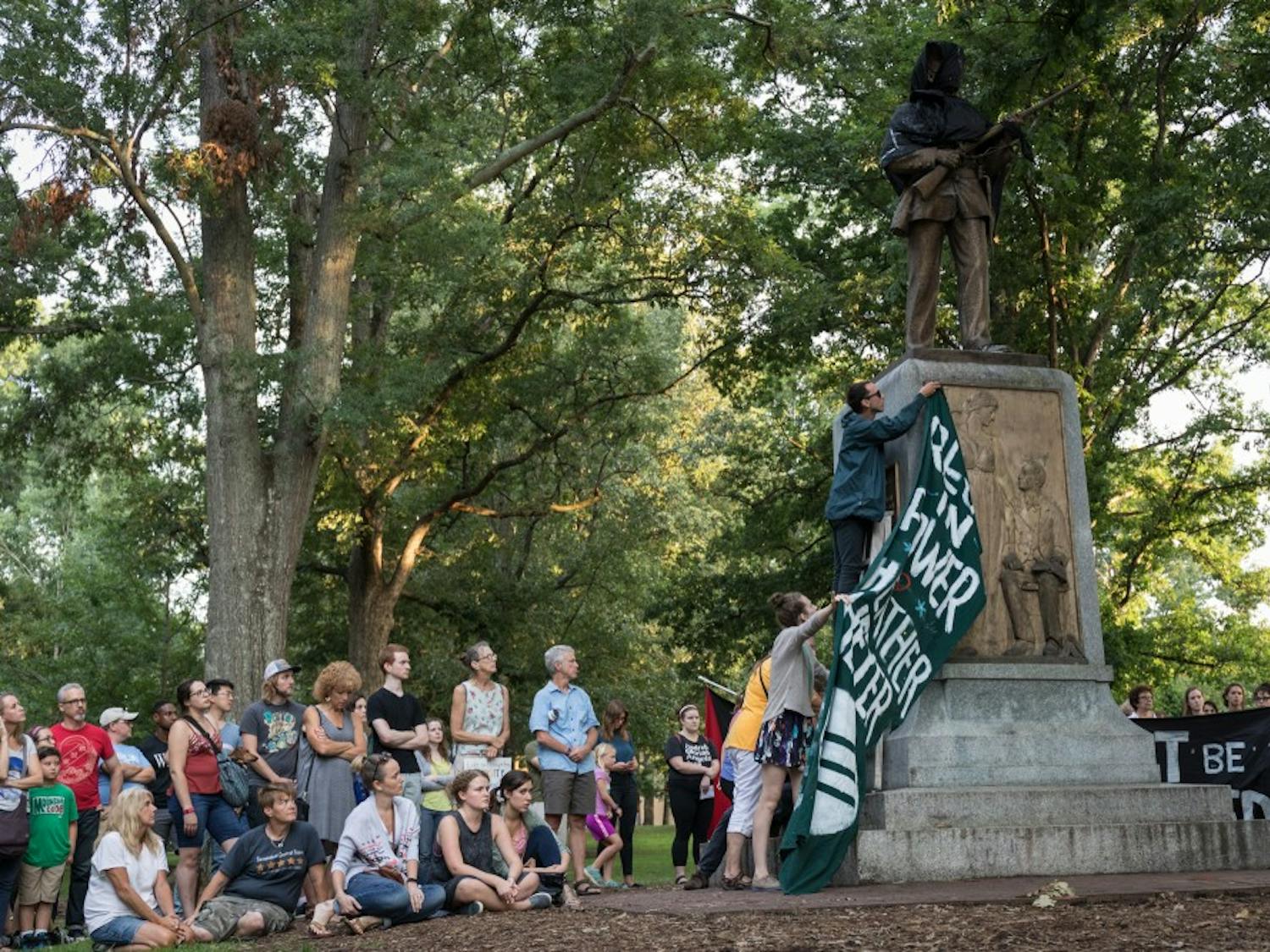 Chapel Hill residents and UNC students gathered on Sunday for a vigil in solidarity with victims of violence in Charlottesville.