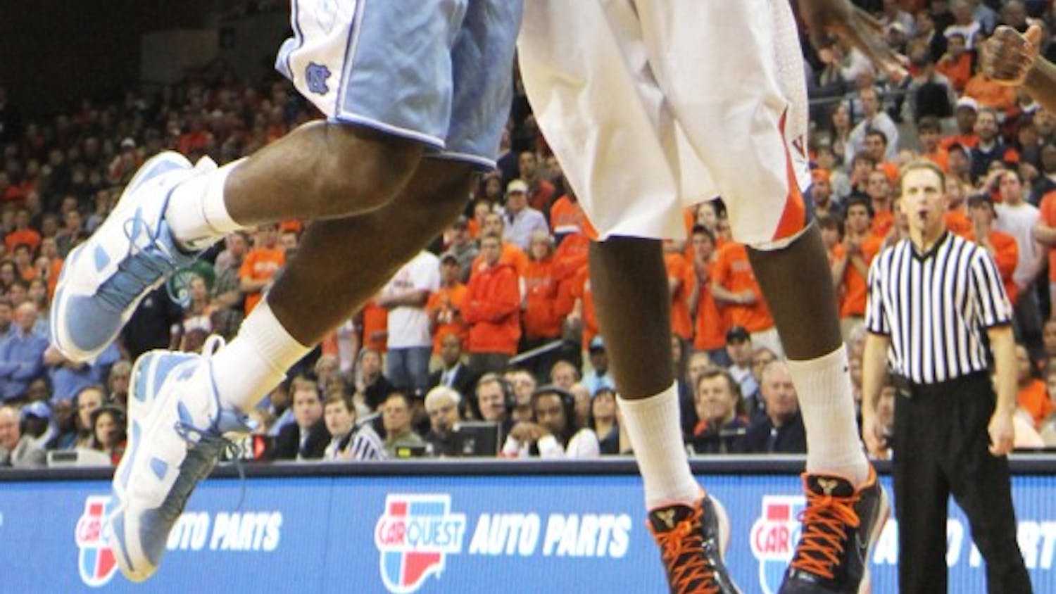 Justin Watts is stuffed by Virginia’s KT Harrell, but the Tar Heels managed to rally for a 62-56 victory. Though Harrell led all scorers with 13 points, both teams shot below 27 percent in the second period.