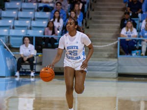 UNC junior guard Deja Kelly (25) looks for a way around her opponent to pass the ball during the women's basketball game against Notre Dame on Sunday, Jan. 8  at Carmichael Arena. UNC beat Notre Dame 60-50.