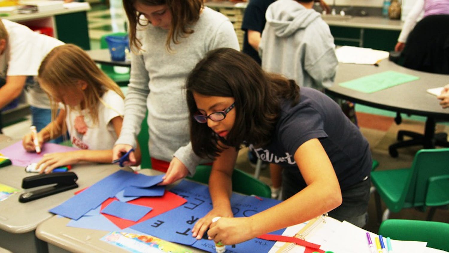 Keelin Caffrey and Soleil Garcia-Johnson work on Soleil's class-president campaign posters.