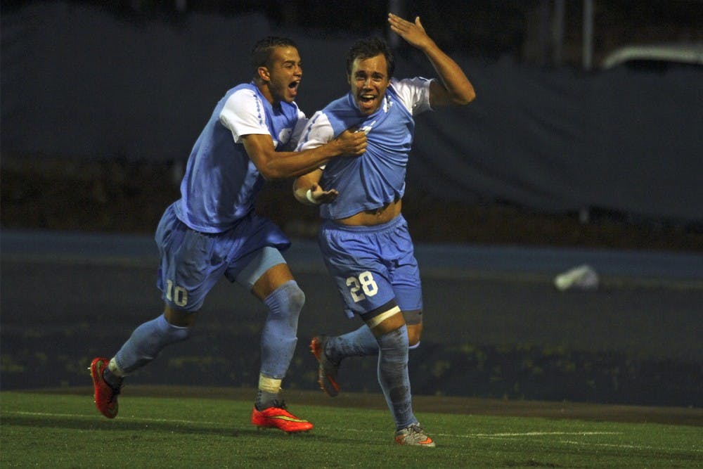 UNC Mens Soccer Game v. Duke with a 2-1 Victory: Forward Zach Wright (10) and Midfielder Alex Olofson (28) celebrates Olofson's goal which came within the first five minutes of play to put UNC up 1-0