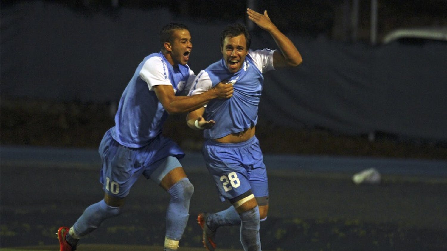 UNC Mens Soccer Game v. Duke with a 2-1 Victory: Forward Zach Wright (10) and Midfielder Alex Olofson (28) celebrates Olofson's goal which came within the first five minutes of play to put UNC up 1-0