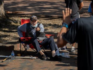 Gary Birdsong, aka "The Pit Preacher," looks on as UNC junior exercise and sport science major Michael Spragley freestyles in the Pit on Sept. 10, 2021.