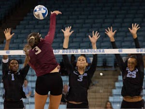 UNC sophomore outside hitter Destiny Cox (1), &nbsp;junior middle blocker Aristea Tontai (3) and redshirt first-year outside hitter Lauren Harrison (25) attempt to block the ball from Seminole first-year opposite hitter Kirstyn Anderson (3). UNC won against FSU 3-2 at Carmichael Arena on Sunday, Oct. 13, 2019.