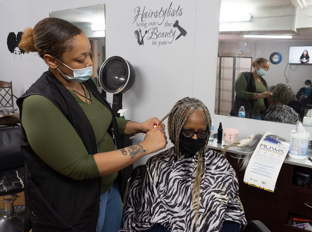 Jasmine Wade of Wade's Hair Studio & Co. styles a customer's hair on Thursday, Jan. 19, 2022. Wade's Hair Studio & Co. is one of several businesses to receive a ReVive recovery grant from the city of Chapel Hill..