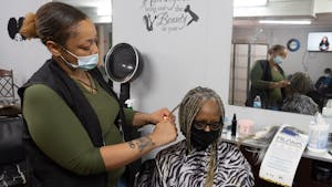 Jasmine Wade of Wade's Hair Studio & Co. styles a customer's hair on Thursday, Jan. 19, 2022. Wade's Hair Studio & Co. is one of several businesses to receive a ReVive recovery grant from the city of Chapel Hill..