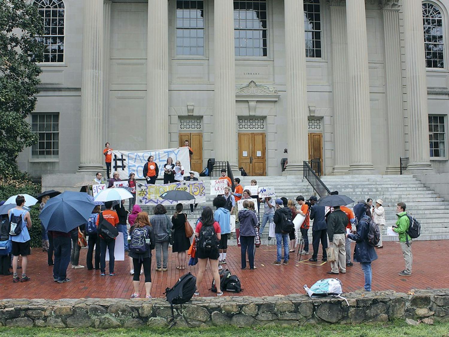 UNC students and faculty gathered in front of Wilson Library Wednesday afternoon to support higher wages for faculty and staff.