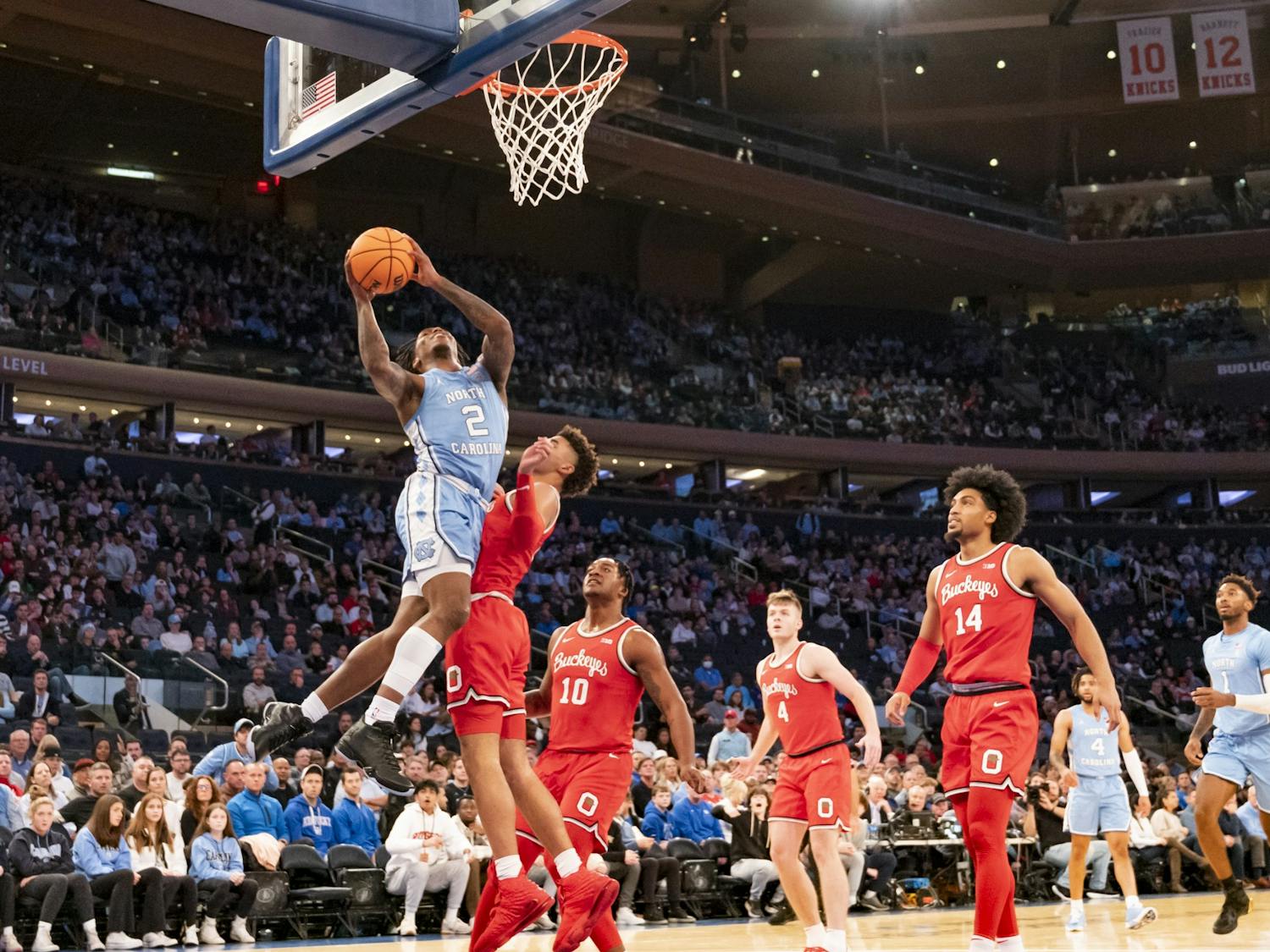 UNC junior guard Caleb Love (2) leaps past Ohio State defense toward the basket during the men's basketball game against Ohio State at Madison Square Garden on Saturday, Dec. 17, 2022. UNC beat Ohio State 89-84.