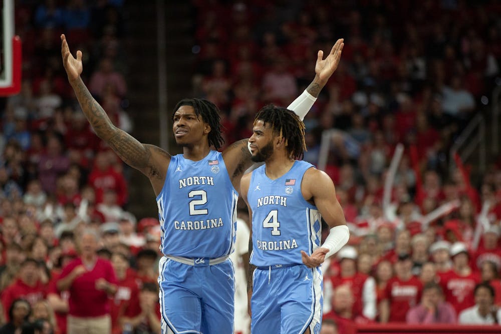 <p>UNC junior guards Caleb Love (2) and RJ Davis (4) react to a call against Love at PNC Arena on Feb. 19, 2023 at the UNC mens basketball game against N.C. State.</p>