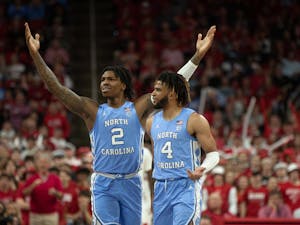 UNC junior guards Caleb Love (2) and RJ Davis (4) react to a call against Love at PNC Arena on Feb. 19, 2023 at the UNC mens basketball game against N.C. State.