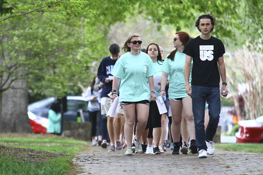 UNC students participate in a walk as a part of the “It’s On Us” even, which sought to raise awareness of and prevent sexual assault.