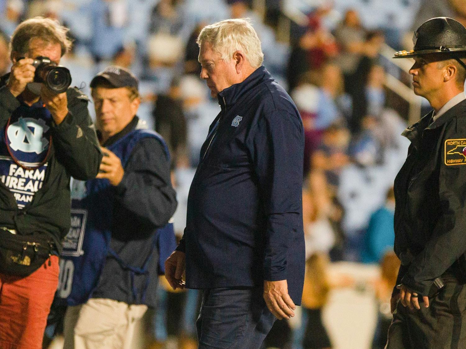 UNC head coach Mack Brown walks off the field after a devasting loss at the game against Florida State on Oct. 9 at Kenan Stadium. The Heels lost 35-25.