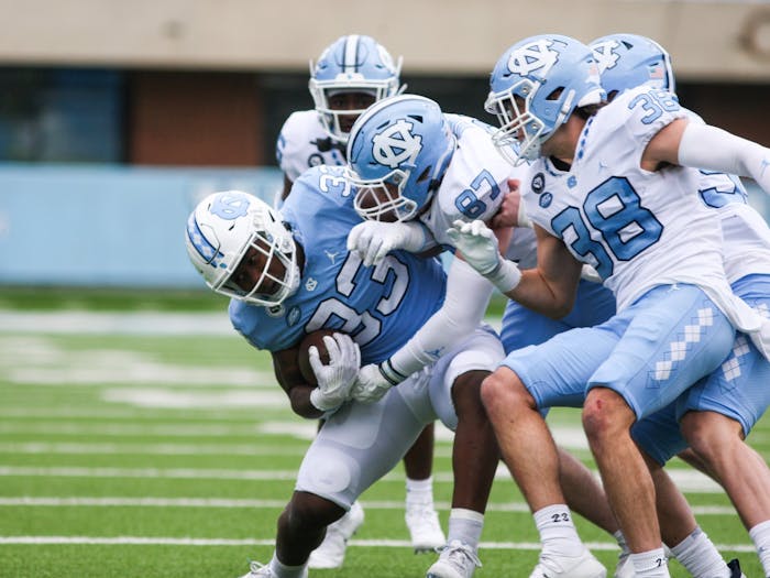 Redshirt freshman running back Kamarro Edmonds (33) protects the ball in the Spring Game on Saturday, April 9, 2022. The Tar Heels and Carolina tied, 14-14.