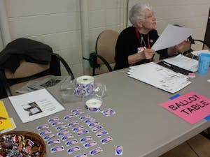 Emilie de Luca works the check-in table at the UNC System Office, the polling place for Greenwood precinct on Tuesday, Nov. 5, 2019.